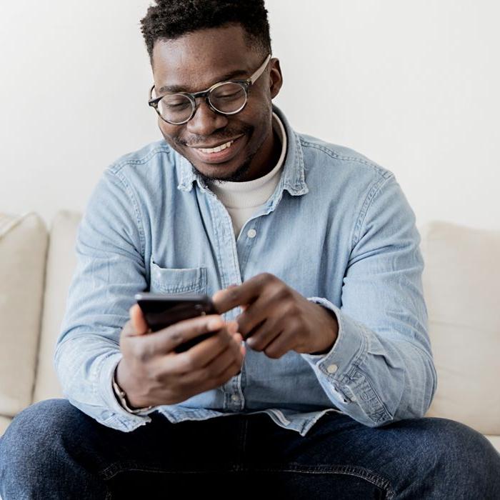 A man uses the Patelco Mobile App from his smartphone.