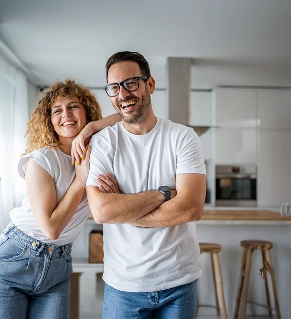 Couple looking away from the camera indoors smiling